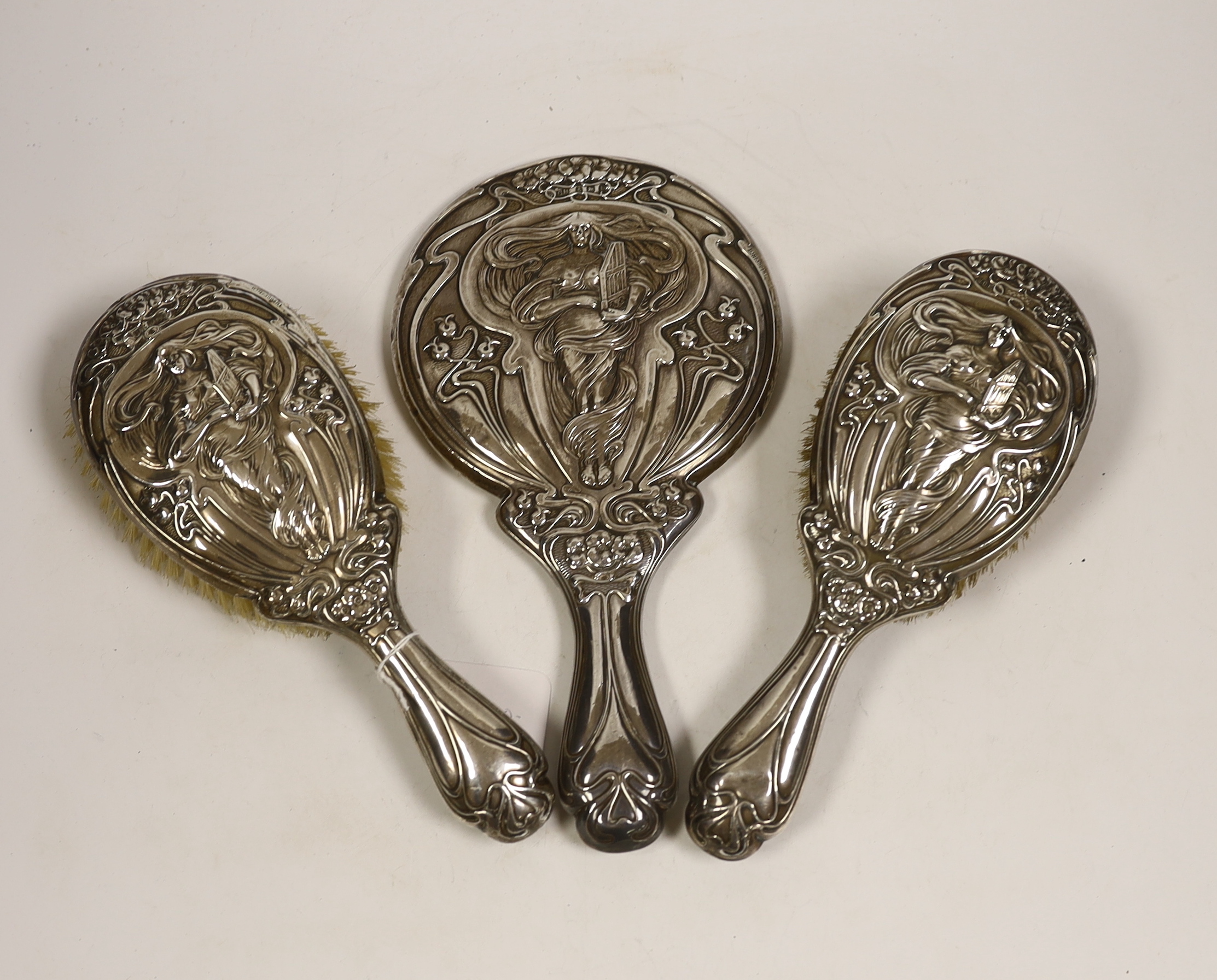 An Edwardian Art Nouveau silver mounted hand mirror and hair brush, maker Charles Horner?, Birmingham, 1906/7 and a similar hair brush, W.G. Keight & Co, Birmingham, 1905.